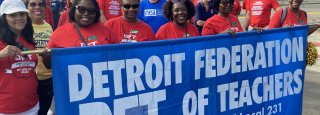 members behind the DFT banner at Labor Day parade