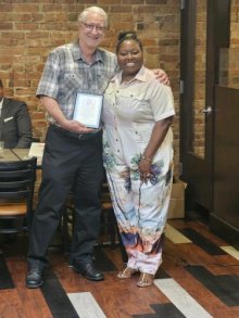 Retiring AFT Michigan President, David Hecker, receives a plaque from DFT President, Lakia Wilson-Lumpkins.